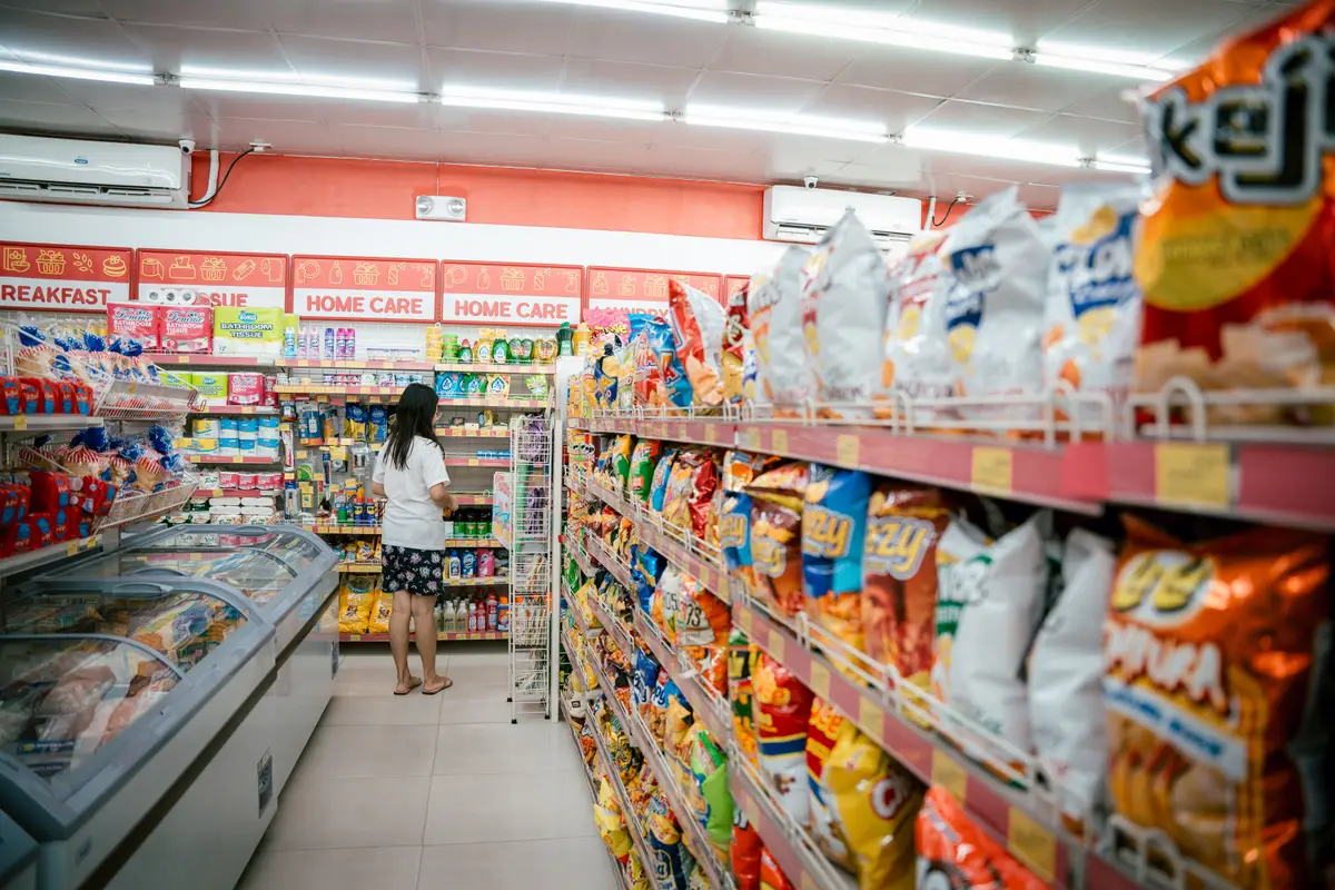 A convenience store aisle with a chest freezer and stocked shelving — convenience store insurance in Oregon.
