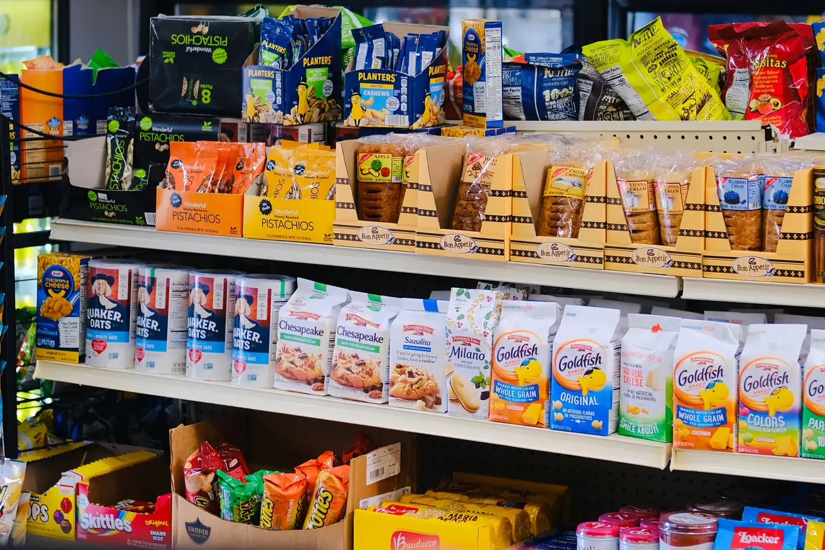 Packaged snacks and groceries on convenience store shelves — convenience store insurance.